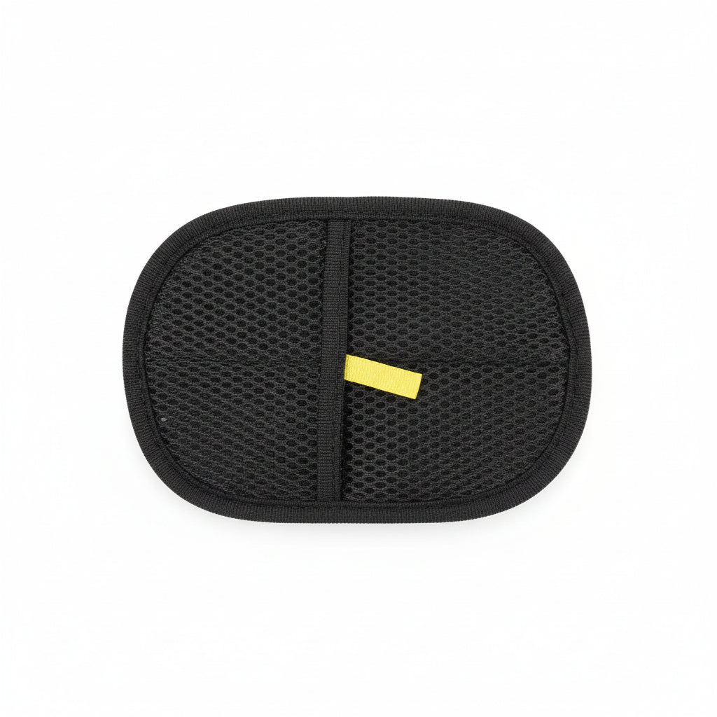 Black mesh pouch held by a hand on a wooden floor