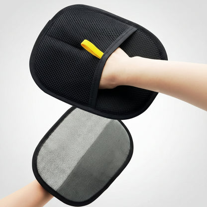 Black and gray cushion with a yellow tag held by a person against a blurred background