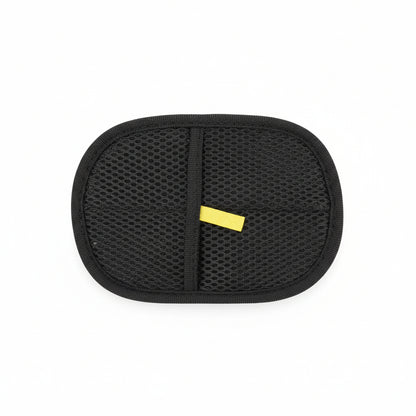 Black mesh pouch held by a hand on a wooden floor